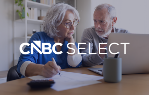 Older couple reviewing finances on a laptop with the CNBC Select logo overlaid