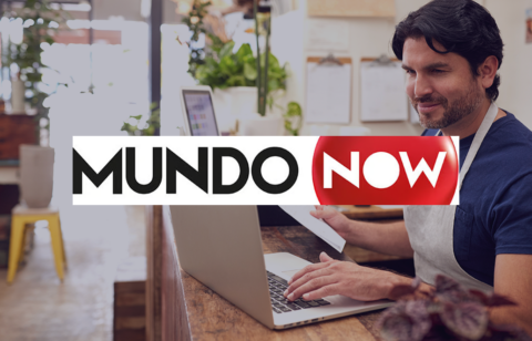 Man working on a laptop with the MundoNow logo overlaid